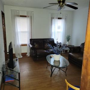 a living room with a couch and a table at Entire house - 4 Bedroom-Enfield in Enfield