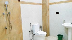 a bathroom with a shower and a toilet and a sink at Rooms Trincomalee Low Price in Trincomalee