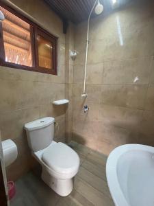 a bathroom with a toilet and a sink and a tub at TATA BEACH in Cadjèhoun