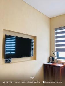 a flat screen tv on the wall of a room at Shelter Stay Da Nang in Da Nang