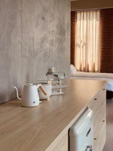 a kitchen with white appliances on a wooden counter at BASED - Mersing in Mersing