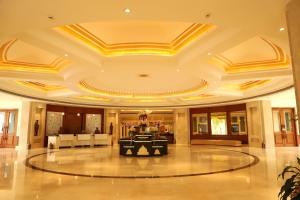 a large lobby with a table in the middle of it at Hotel Chandela Khajuraho in Khajurāho