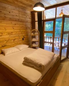 a bedroom with a bed and a wooden wall at Moi in Rize