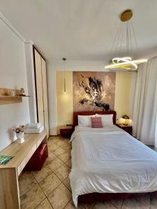 a bedroom with a bed and a painting on the wall at City1 lux apartment in Serres
