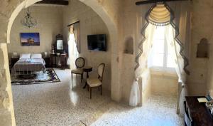 a bedroom with a bed and a window at Nina in Siġġiewi