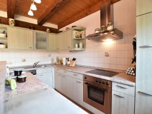 a kitchen with white cabinets and a stove top oven at Fabulous Holiday Home in Thorstorf near Sea in Thorstorf
