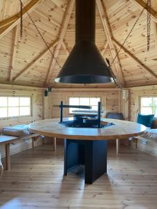 a large kitchen with a table in a wooden room at Maison bois kota / bain nordique / proche de la mer / kota grill in Longueil