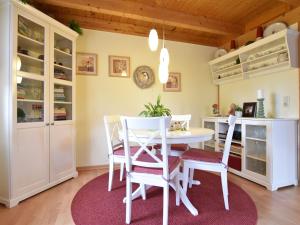 a dining room with a white table and chairs at Fabulous Holiday Home in Thorstorf near Sea in Thorstorf