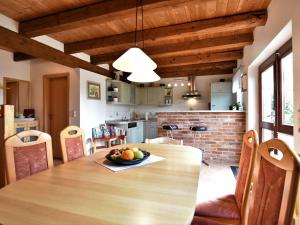 a kitchen and dining room with a wooden table with a bowl of fruit at Fabulous Holiday Home in Thorstorf near Sea in Thorstorf