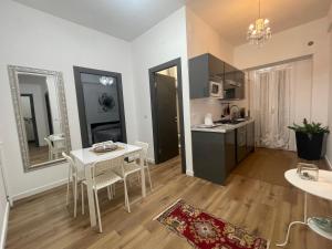 a kitchen and living room with a table and chairs at Dreamsrome Lux in Rome