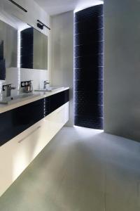 La salle de bains blanche est pourvue d'un lavabo et d'un miroir. dans l'établissement Hotelik u Sąsiada, à Olsztyn