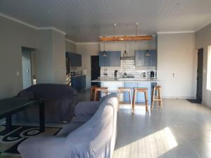 a living room with a couch and a kitchen at Saldeseas in Strandfontein