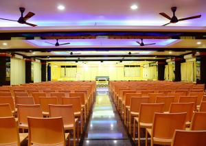 an empty lecture hall with chairs and ceiling fans at Hotel Tri Sea in Kanyakumari