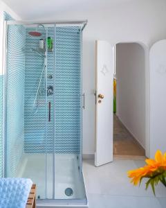a shower with a glass door in a bathroom at Casa Dreaming Ortigia in Siracusa