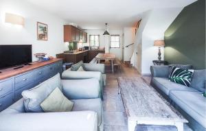 a living room with blue couches and a table at Stunning Home In Saint-Laurent-De-La-Cabrerisse in Saint-Laurent-de-la-Cabrerisse