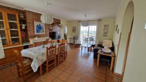 a kitchen and dining room with a table and chairs at El Refugio in Turís