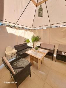 a room with a tent with a table and chairs at DELUXE TOP CENTER House with garden's tent ,2 bedrooms and living room next to the BEACH and SEA GARDEN- 5 min by walk,with equiped kitchen in Burgas City