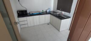 a small kitchen with a sink and a microwave at Lodge 16 Private Villa in Kuah +25 photos