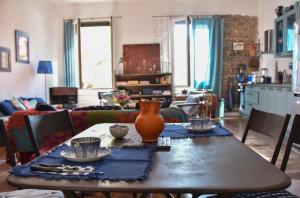 a table with a vase on top of it in a living room at La Maison d'Elysa in Perpignan