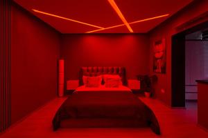 a red bedroom with a bed with red walls at Modern Studio ground floor & designer lighting in Timişoara