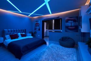 a blue bedroom with a bed and a blue ceiling at Modern Studio Escape in Timişoara