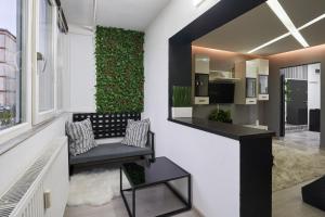 a living room with a bench and a green wall at Modern Studio Escape in Timişoara