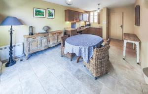 a kitchen with a table and chairs in a room at Gorgeous Home In Saint-Laurent-De-La-Cabrerisse in Saint-Laurent-de-la-Cabrerisse