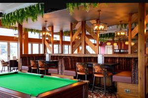a pool table in a bar with chairs and a pool table at Caravan Holidays at Sand le mere in Tunstall