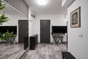 a room with three doors and a table and chairs at Modern Studio Escape in Timişoara +4 photos