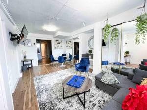 a living room with a couch and blue chairs at Quiet Home Near SFO with Backyard / BBQ in San Bruno