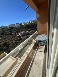 a balcony with a bench and a view of a city at La Bella Guesthouse in St. Julianʼs