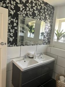 a bathroom with a sink and a mirror at Palm - Bournemouth in Bournemouth