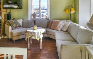 a living room with a couch and a table at Cozy Home In Stnga With Wifi in Stånga