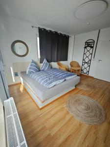 a bedroom with a bed and a wooden floor at MiNe Boutique Hotel in Weilerswist