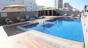a large swimming pool on top of a building at Grand Kingsgate Jaddaf Waterfront Hotel by Millennium in Dubai