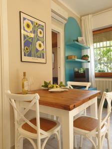 a dining room with a table and two chairs at Marty&Olly Luxury Garden Apt in Monterosso al Mare