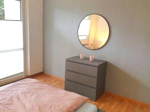 a bedroom with a mirror and a dresser with pink candles at Ferienwohnung ErzHome in Marienberg
