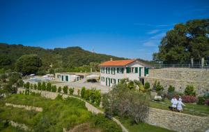 two people standing in front of a building at Il Leccio - Luxury Resort Portofino Monte in Santa Margherita Ligure