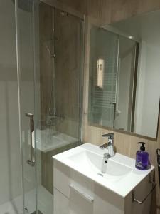 a white bathroom with a sink and a shower at A&a MADRID in Madrid