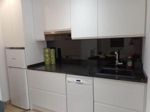 a kitchen with white cabinets and a sink at A&a MADRID in Madrid