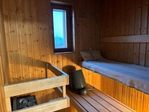 a room with two beds in a wooden cabin at Top floor in central Leppävaara in Espoo