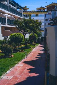 a sidewalk with trees in front of a building at Casa Costa del Sol Beach&Golf,Marbella in Sitio de Calahonda