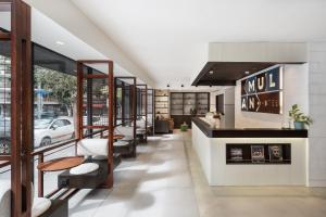 a lobby of a restaurant with a row of chairs at Mulan Hotel in Tel Aviv