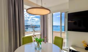 a dining room with a table and a large window at Apartments & Rooms Grašo in Split