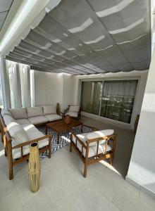 a living room with a couch and a table at Duplex penthouse close to the beach in Costa Ballena