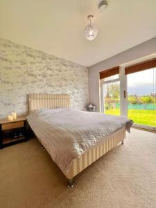 a bedroom with a large bed and a window at Moate - One Bedroom Self Contained Apartment in Moate
