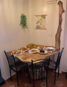 a table with plates of food on top of it at Green Heart Homestay in Nuwara Eliya