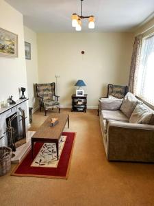 a living room with a couch and a coffee table at Sneem Townhouse in Sneem