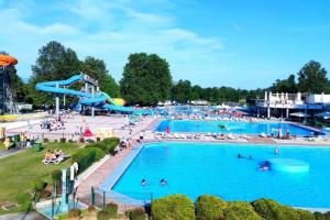a large swimming pool with a water park at Miabella House - 2 bedrooms and terrace in Brežice