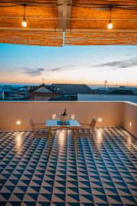 a table and chairs on the roof of a building at DIMORA NIKARE' Sicilian House in Sciacca